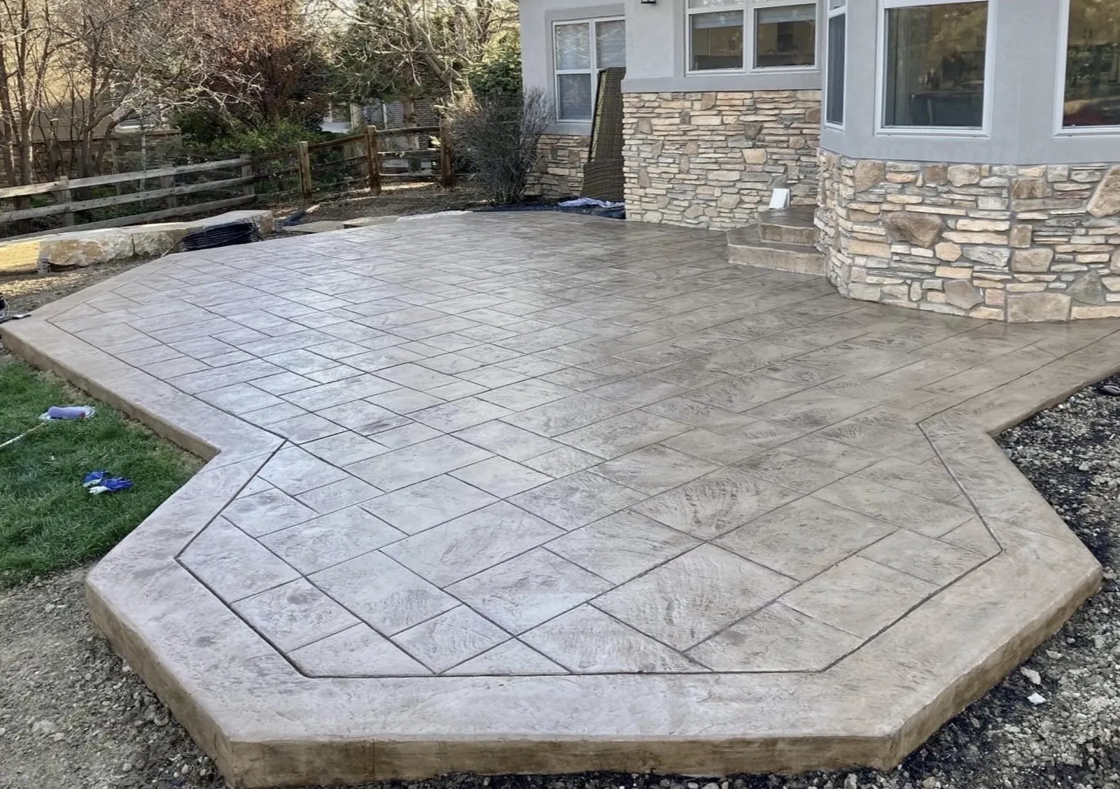 Stamped slate-pattern concrete patio with a border band